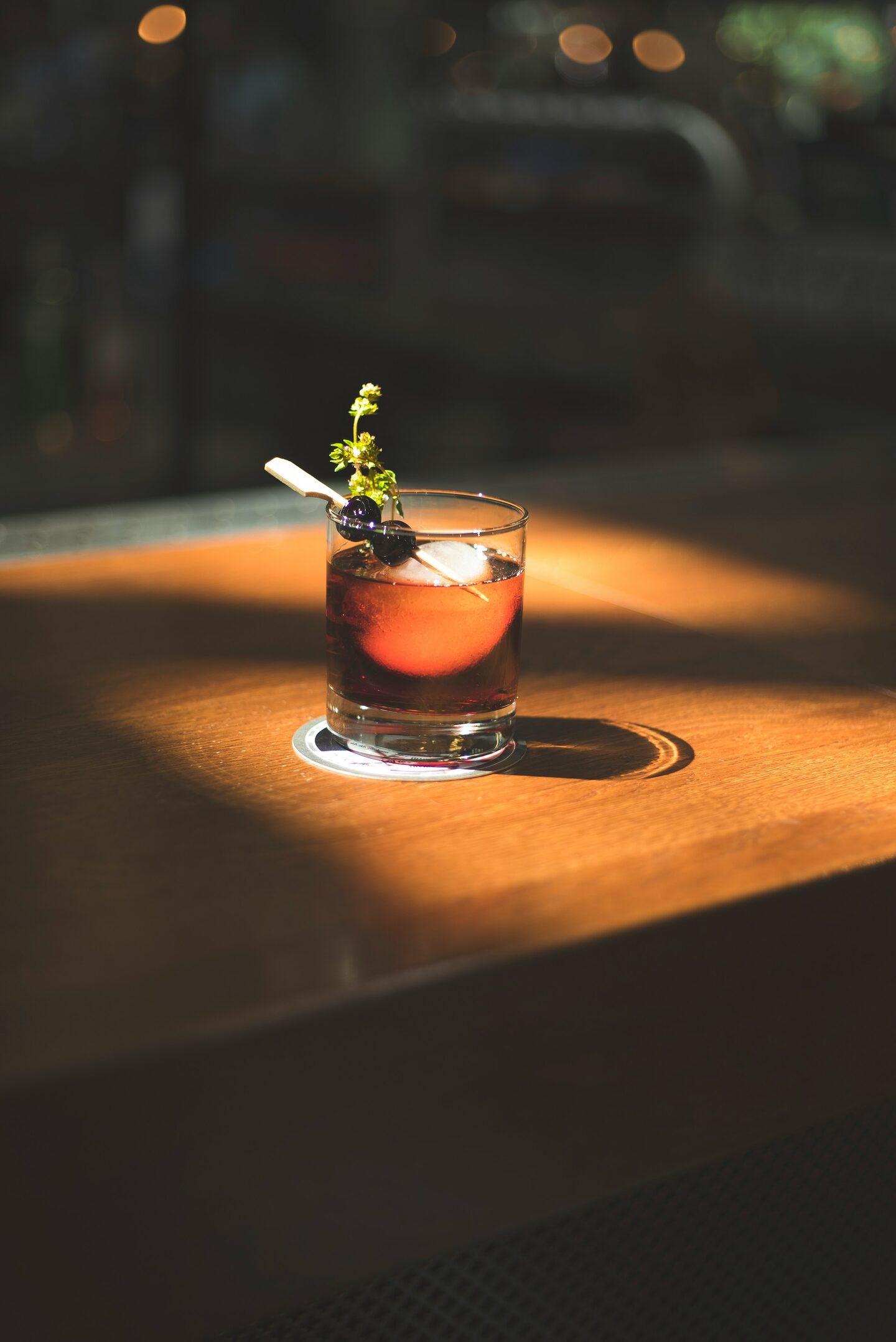 A signature cocktail in a coupe glass with a citrus twist.